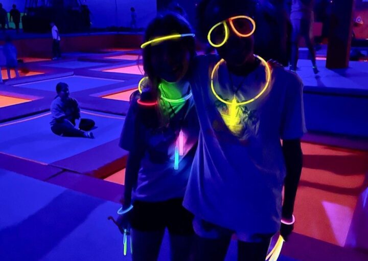 Guests at Ground Control OKC Glow Night wearing neon glow accessories